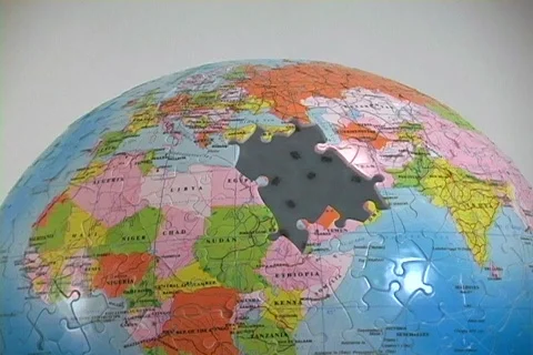 A world globe puzzle has the Middle East pieces missing. Stock Footage 341142