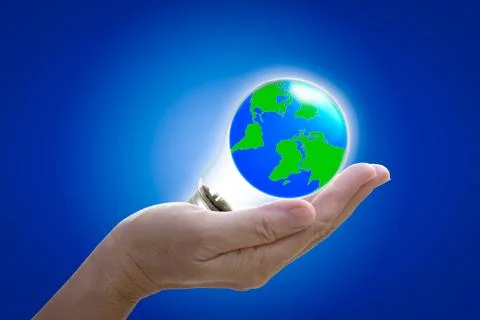 The world in light bulb on the hand Stock Photos