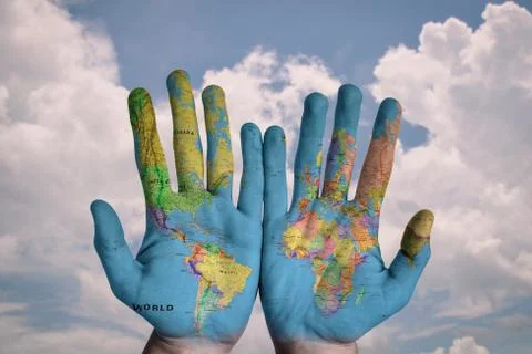 World map is painted on both hands of a man Stock Photos