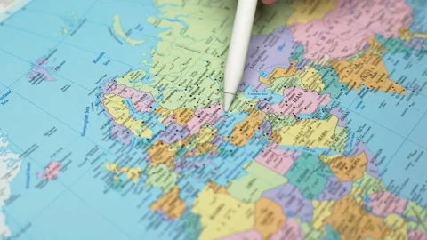 World map, a pointer in a man's hand outlines the borders of different countries Stock Footage 234627567