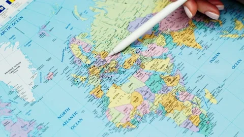 World map pointer in woman's hand outlines borders countries Ukraine and Russia Stock Footage 234593090
