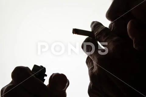 World No Tobacco Day; The silhouette of an elderly Asian man is smoking Stock Photos