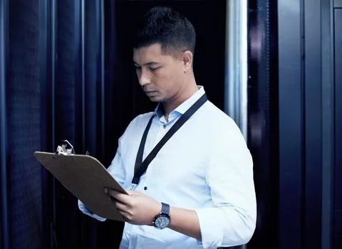 In the world of tech, he knows whats up. a young man making notes while working Stock Photos