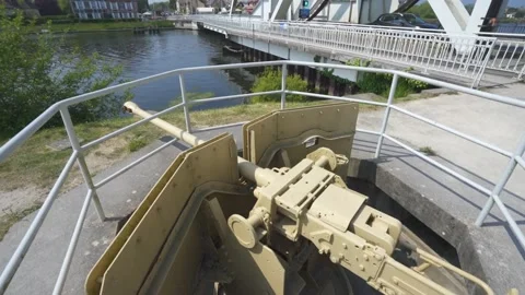 World War 2 Artillery gun overlooking Caan River and Pegasus Bridge in Stock Footage 224092149