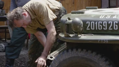 World War 2 – Germans preparing caputed Jeep for changing the paint Stock Footage