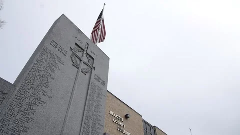 World War II US war Veterans monument with flag in background and white sky Stock Footage 192472280