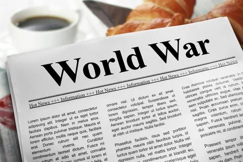 World War in newspaper layout on a breakfast table with a blurry cup of cof.. Stock Photos