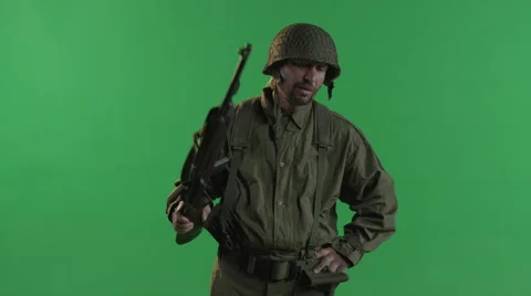 A World War Soldier Pulls His Firearm From His Shoulder And Smiles. Stock Footage 45295416