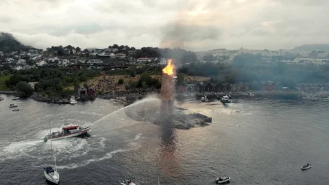 World's biggest bonfire burning. Firefighter boat control the burning. Stockbeeldmateriaal 91400859