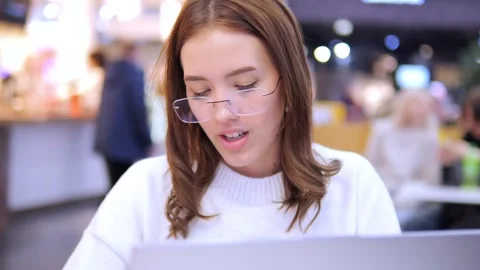 Worldwide work Female developer working on laptop sitting cafe in mall. Woman Stock Footage 270540662