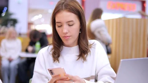 Worldwide work Female developer working on laptop sitting cafe in mall. Woman Stock Footage 270961582