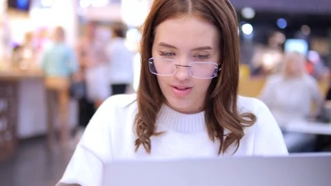 Worldwide work Female developer working on laptop sitting cafe in mall. Woman Stock Footage 274517939