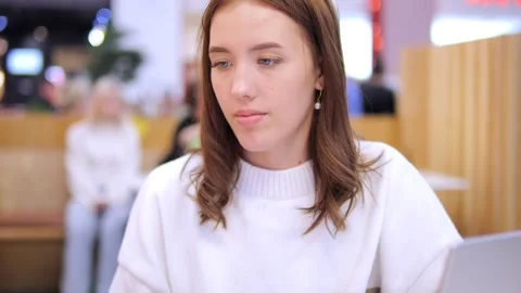 Worldwide work Female developer working on laptop sitting cafe in mall. Woman Stock Footage 274662170