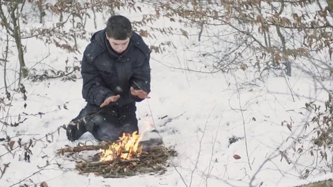Worming up hands over bonfire in show Stock-Footage 72748928