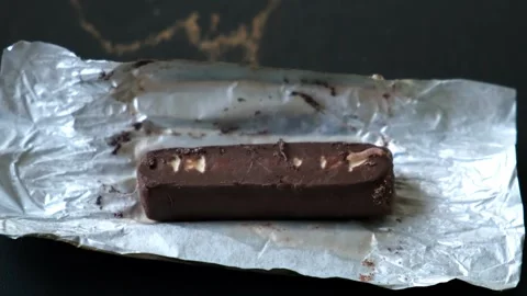 Worms crawls on chocolate candy. Crawling larvae and eggs laid on food. Not Stock Footage 289474317