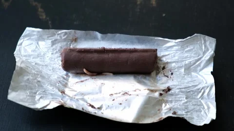 Worms crawls on chocolate candy. Crawling larvae and eggs laid on food. Not Stock Footage 291105448