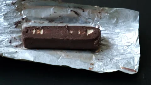 Worms crawls on chocolate candy. Crawling larvae and eggs laid on food. Stock Footage 292083822