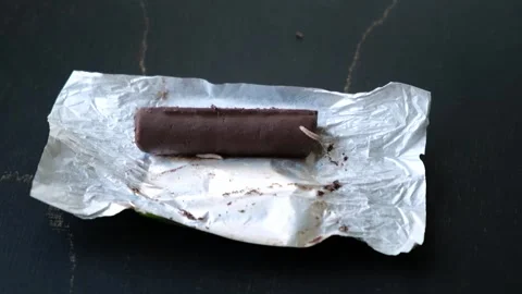 Worms crawls on chocolate candy. Crawling larvae and eggs laid on food. Stock Footage 292677833