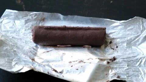 Worms crawls on chocolate candy. Crawling larvae and eggs laid on food. Stock Footage 292677971
