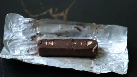 Worms crawls on chocolate candy. Crawling larvae and eggs laid on food. Stock Footage 295107372