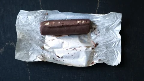 Worms crawls on chocolate candy. Crawling larvae and eggs laid on food. Stock Footage 295107400