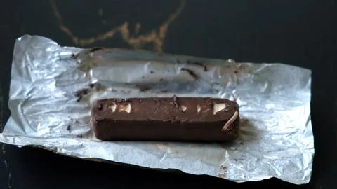 Worms crawls on chocolate candy. Crawling larvae and eggs laid on food. Not.. Stock Photos