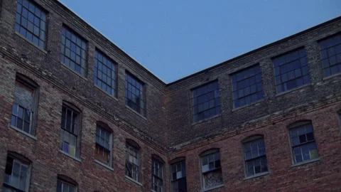 Worm's eye view of an abandoned brick factory or warehouse with broken windows Stock Footage 336226139