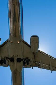 Worm's eye view of a plane with a clear sky in the background Stock Photos