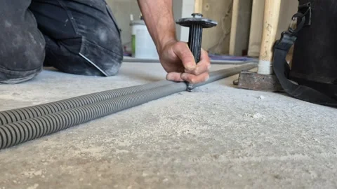 Worms Eye View of Worker Fixing Concrete Nail Into Ceiling Slab 動画素材 340643674