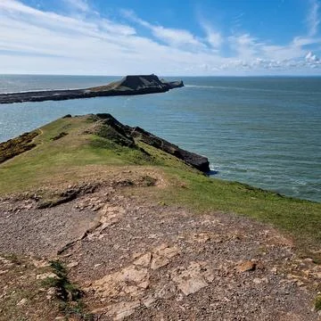Worm's Head is a tidal island located on the Gower Peninsula in South Wales.. Stock Photos