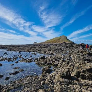 Worm's Head is a tidal island located on the Gower Peninsula in South Wales.. Stock Photos