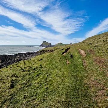 Worm's Head is a tidal island located on the Gower Peninsula in South Wales.. Stock Photos