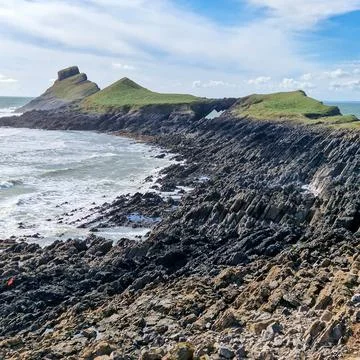 Worm's Head is a tidal island located on the Gower Peninsula in South Wales.. Stock Photos