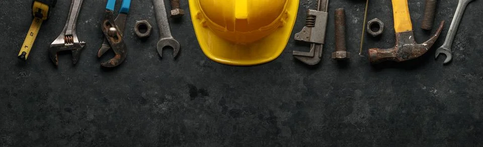 Worn and used work tools with a yellow construction hard hat. Home improvem.. Stock Photos