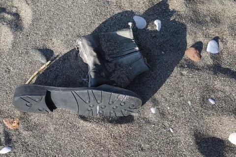 Worn boot in the sand on Turkish beach Stock Photos