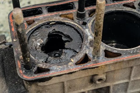 Worn broken piston in the cylinder. Engine detail close-up. Stock Photos