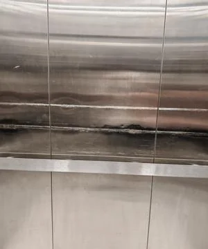 Worn Brushed Stainless Steel Elevator Interior with Scratched Metal Panels Stock Photos