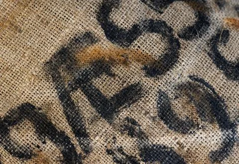 Worn burlap coffee sack close-up showing coarse jute weave texture Stock Photos