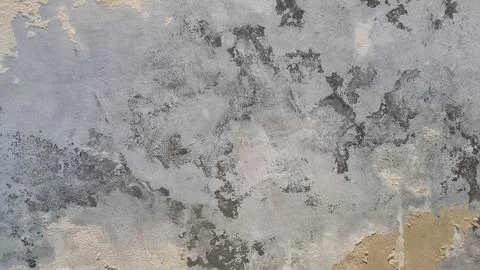 Worn cement wall with visible cracks, stains, and rough grunge texture. Use.. Stock Photos