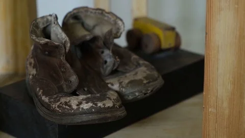 Worn child leather boots with wood toy Stock Footage 114012053