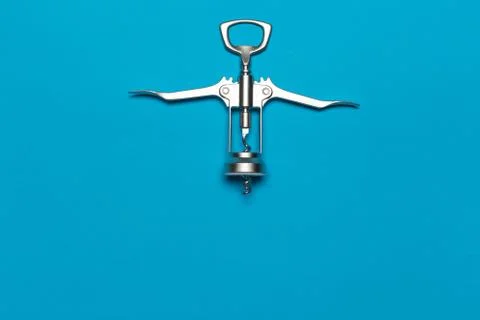 Worn Chrome Plated Wing Corkscrew Reverse Side on blue Background Stock Photos