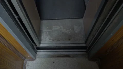 Worn elevator threshold with exposed materials. Aged elevator entryway with Stock Footage 335684302