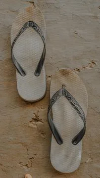 Worn Flip Flops on Cracked Surface Fotos Stock