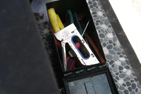 Worn Hand Stapler and Tools in a Toolbox Stockfoto's