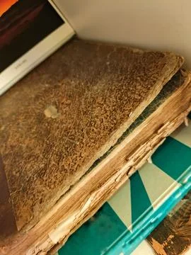 Worn leather-bound book on table Photos