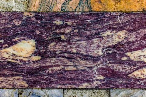 Worn Marble Floor Tile with Dominant Purple Veins Фото