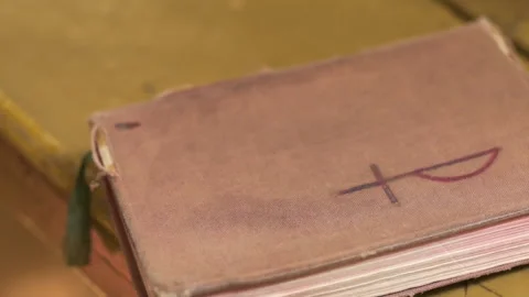 Worn old book on wooden table in warm light 스톡 동영상 336466839