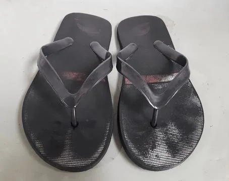 Worn-out black flip-flops Stock Photos