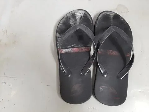 Worn-out black flip-flops Stock Photos