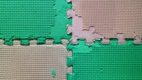 Worn out interlocking EVA foam puzzle play mat texture Stock Photos